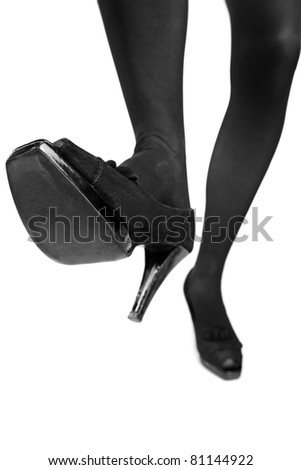 A view of a woman high heels about to step isolated on white background