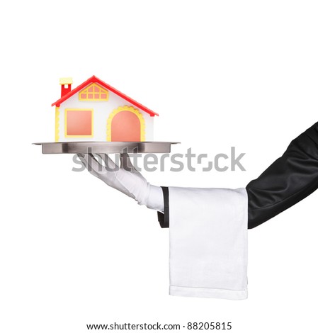 A waiter holding a silver tray with a house model on it isolated on white background