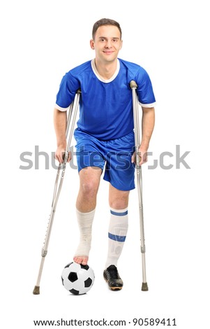 Full Length Portrait Of An Injured Soccer Football Player On Crutches ...