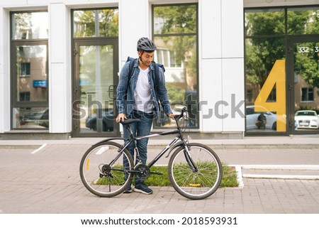 Similar – Image, Stock Photo Man riding bike next to buildings