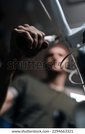 Image, Stock Photo Focused craftsman repairing handlebar with fire