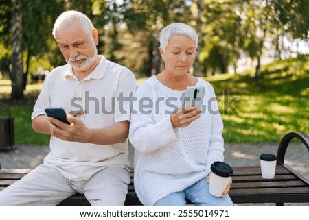 Similar – Foto Bild Friedliche Frau, die auf der Promenade bei Sonnenuntergang auf ihrem Smartphone surft