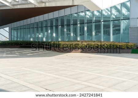 Similar – Image, Stock Photo Empty parking lot. A sign ‘Lehrerparkplatz’ in front of a school building with closed shutters