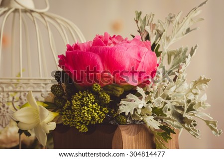 flowers in the wooden vase on the table