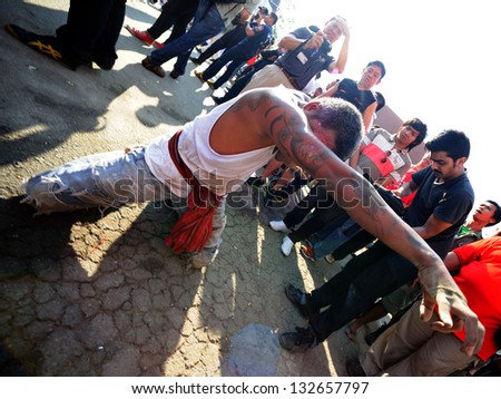 NAKHON CHAISI, THAILAND - MARCH 23: Participants at the wai khru ceremony fall into a deep trance on March 23, 2013 in wat bang phra, thailand.