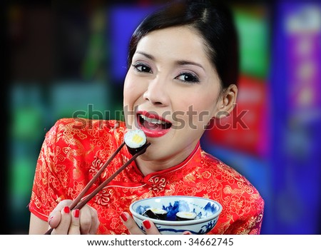 young asian woman eating sushi on a colored background