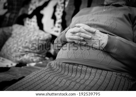 Closeup of an old woman\'s hands joined , focus on hands