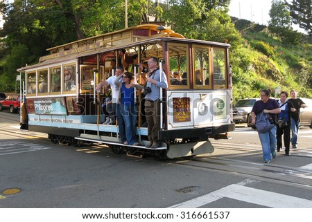 Tourists and commuters, passengers on cable car at Van Ness Avenue, Russian Hill, San Francisco, California, USA