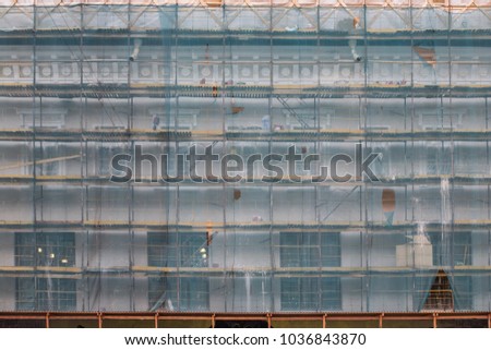 Similar – Image, Stock Photo Scaffolding with protective net and tarpaulin from frog perspective / house renovation