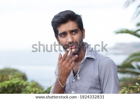 Similar – Image, Stock Photo Ethnic man smoking in studio with neon lights