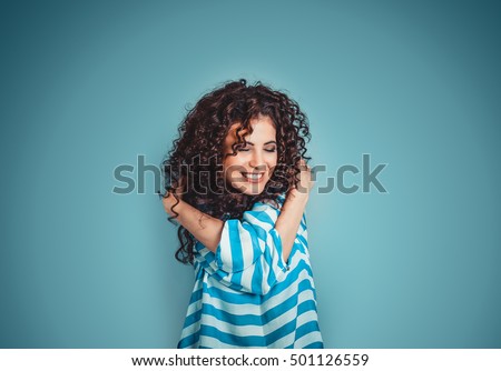 Photo of Closeup portrait confident smiling woman holding hugging herself isolated blue wall background. Positive human emotion, facial expression, feeling, reaction, situation, attitude. Love yourself concept
