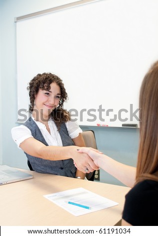 Woman shaking hands with a client/Business Relation