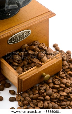 wooden coffee grinder with beans on white