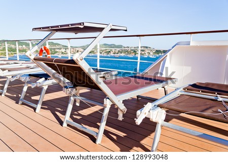 Pleasing and relaxing view from the deck on a cruise ship for summer vacation, with chairs. This is good to advertise vacation and holidays on cruises.