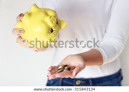 Body part - yellow pig in woman hands