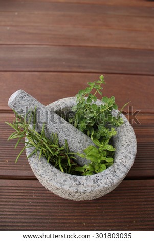 Healthy and fragrant herbs in a stone mortar