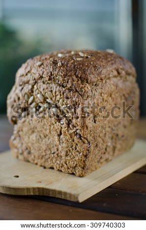 Pieces of homemade wholemeal bread over wooden table with clean table napkin