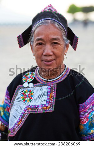 YUANYANG, CHINA - MAY 04: Unidentified Hani woman in national clothes poses for a photo during Yuanyang festival on May 04, 2014 in Yuanyang, China.