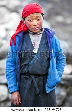 LHO, MANASLU CONSERVATION AREA, NEPAL - NOVEMBER 29: Tibetan girl Pema, 14, poses for a photo on the road to Lho village on November 29, 2009 in Gorkha District, Nepal