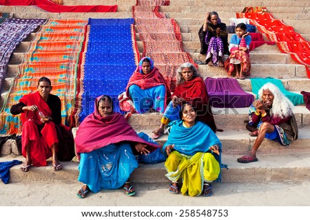 VARANASI, UTTAR PRADESH, INDIA - JANUARY 15: Indian women dry their saris  at Dashashwamedh ghat after bathing in the sacred Ganges river on January 15, 2010 in Varanasi, State of Uttar Pradesh, India