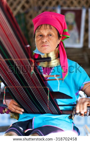 BAGAN, MYANMAR - JANUARY 9: Padaung tribe woman working in a textile mill on January 9, 2012 in Bagan, Myanmar. Padaung is a Shan term for the Kayan Lahwi people.
