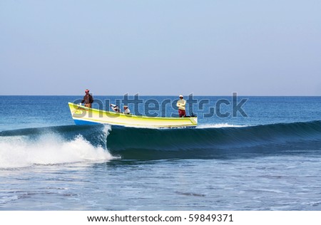 VARKALA, SOUTH INDIA - FEBRUARY 08: Fishing in wooden boat at Arabian sea by local fishermans February 08, 2010 in Varkala, State of Kerala, South India