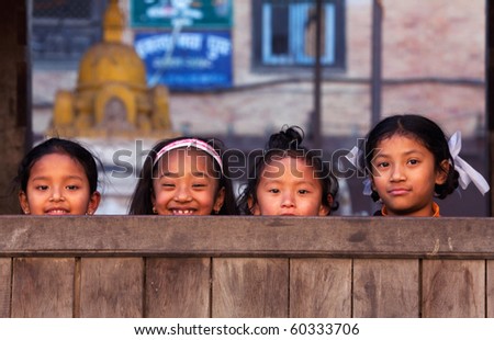 BHAKTAPUR, NEPAL - JANUARY 08: Group of Nepalese schoolgirl - outdoor games on the street of old town on January 08, 2010 in Bhaktapur, Kathmandu Valley, Nepal.