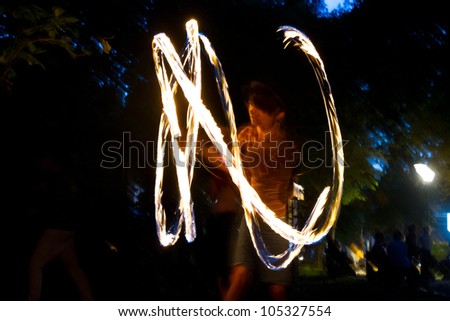 BUCHAREST - JUNE 16: Fire jugglers perform in \'Gradina Icoanei\' Park during Street Delivery 2012 - Day 2, on June 16, 2012 in Bucharest, Romania