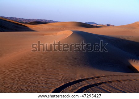 Desert safari dune bashing near Dubai, at sunset.