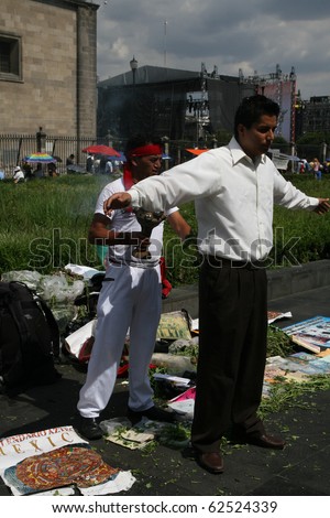MEXICO CITY - JULY 28: Unknown people executing amerindian rituals in the square in front of Mexico City Cathedral and Metropolitan Tabernacle, Mexico City, Mexico, on 28 July 2010.