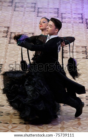 BUCHAREST - APRIL 17: Ballroom dancers Paraschiv Mihai & Illes Diandra take first place in the Open 14 - 15 Years Standard category at the Dance Masters competition on April 17, 2011 in Bucharest, Romania