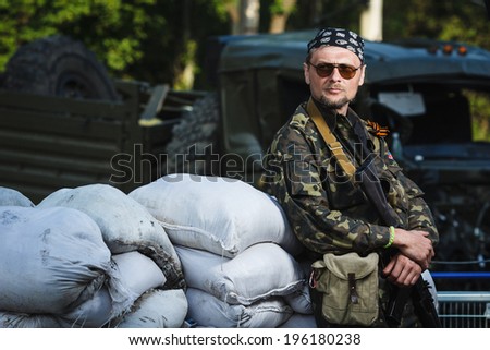 DONETSK, UKRAINE - JUNE 01: One of the fighters at the Russian Orthodox Army\'s block post on the road to the airport on june 01, 2014 in Donetsk.