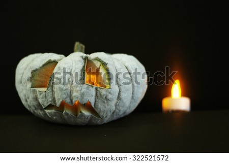 halloween pumpkin head with candle and select point focus at face of pumpkin head