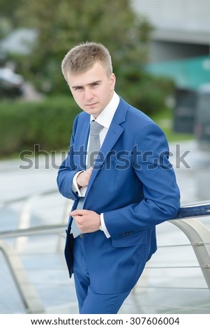 Handsome and attractive businessman in suit, Business Centre Moscow City, Bagration Bridge