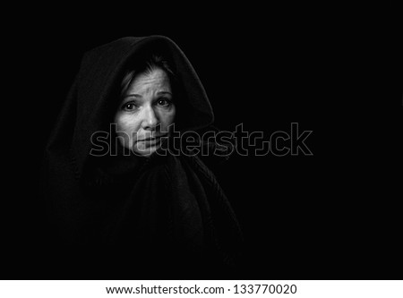 A depressed woman stares emptily into space.