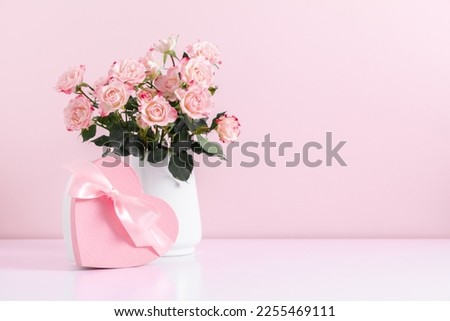 Similar – Image, Stock Photo Bouquet of pink and white flowerson wooden table at flower shop. Floristics and selling flowers small business. Pink fresh spring floral background with copy space on top with light gray background.