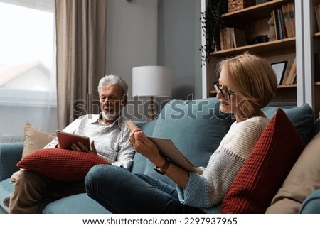 Similar – Image, Stock Photo Mature man reading book at home