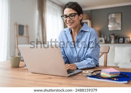 Similar – Image, Stock Photo The young woman in the blue sweater sits comfortably in the armchair and holds a coffee mug and a book in her hands. Upper body portrait without head