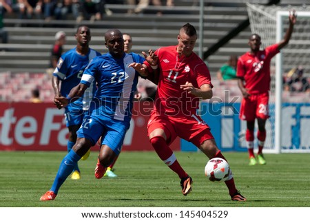 PASADENA, CA - JULY 7: Jean Sylvain Babin #22 of Martinique & Marcus Haber #11 of Canada during the 2013 CONCACAF Gold Cup game between Canada & Martinique on July 7, 2013 at the Rose Bowl.