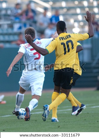 CARSON, CA. - JULY 3: Concacaf Gold Cup soccer match, Canada vs. Jamaica at the Home Depot center in Carson. Ricardo Fuller running down Michael Klukowski on July 3, 2009.