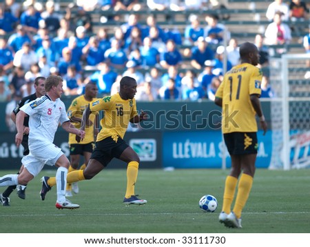 CARSON, CA. - JULY 3: Concacaf Gold Cup soccer match, Canada vs. Jamaica at the Home Depot center in Carson. #16 Jermaine Johnson and #8 Marcel de Jong chase the ball down on July 3, 2009.
