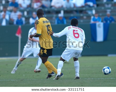 CARSON, CA. - JULY 3: Concacaf Gold Cup soccer match, Canada vs. Jamaica at the Home Depot center in Carson. Jermaine Johnson and Julian de Guzman fight for the ball on July 3, 2009.