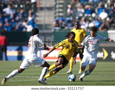 CARSON, CA. - JULY 3: Concacaf Gold Cup soccer match, Canada vs. Jamaica at the Home Depot center in Carson. Ricardo Gardner, William Johnson, and Julian de Guzmanafter the ball on July 3, 2009.