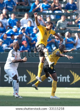 CARSON, CA. - JULY 3: Concacaf Gold Cup soccer match, Canada vs. Jamaica at the Home Depot center in Carson. Tyrone Marshall jumps for the ball while Ali Gerba and Claude Davis watch on July 3, 2009.