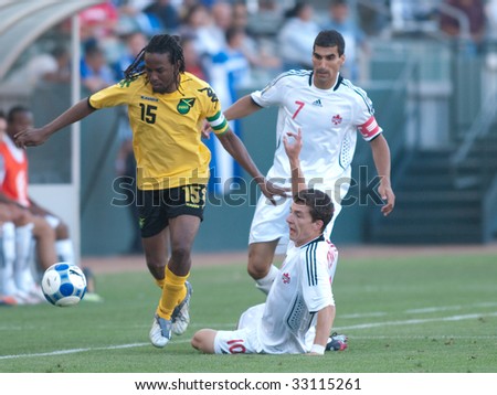 CARSON, CA. - JULY 3: Concacaf Gold Cup soccer match, Canada vs. Jamaica at the Home Depot center in Carson. Ricardo Gardner dribbles past William Johnson and Paul Stalteri on July 3, 2009.