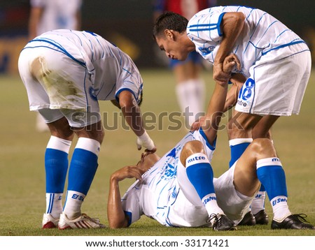CARSON, CA. - JULY 3: Concacaf Gold Cup soccer match, Costa Rica vs. El Salvador at the Home Depot Center in Carson. Injuried player with team mates helping him up. July 3, 2009.