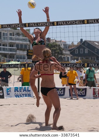 MANHATTAN BEACH, CA. - JULY 18: Jenny Kropp spiking the ball and Chelsea Hayes getting into position at the AVP Manhattan Beach Open on July 18th 2009.
