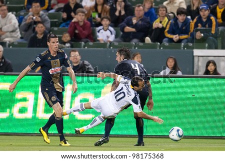 CARSON, CA. - APRIL 2: Los Angeles Galaxy F Landon Donovan #10 gets taken down by Philadelphia Union D Danny Califf #4 during the MLS game on April 2 2011 at the Home Depot Center in Carson, CA.