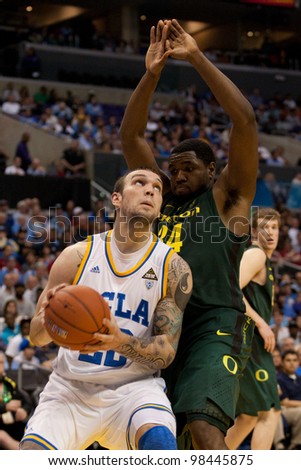 LOS ANGELES - MARCH 10: UCLA Bruins F Reeves Nelson #22 & Oregon Ducks F Joevan Catron #34 during the NCAA Pac-10 Tournament basketball game between on March 10 2011 at Staples Center.