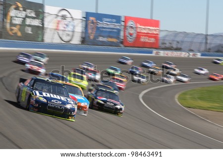 FONTANA, CA. - OCT 10: Sprint Cup Series driver Jimmie Johnson in the Lowe\'s #48 car leads out of turn 2 during the Pepsi Max 400 on Oct 10 2010 at the Auto Club Speedway.
